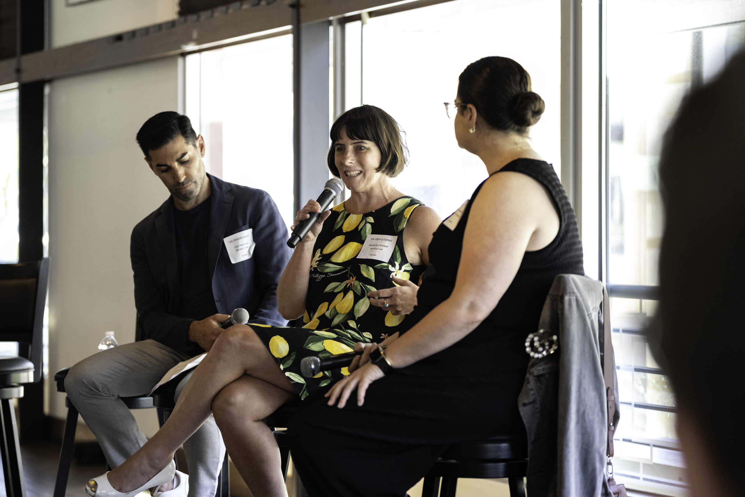 Image of Jon Grauman, Maggie, and Jacki Granet sitting while speaking at The Creator Summit