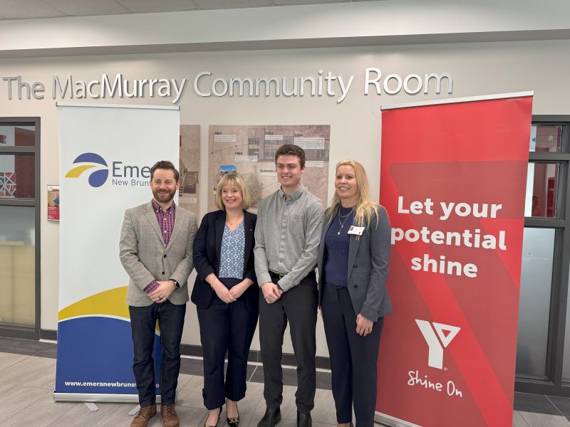 Janet Thompson-Price and colleagues standing in front of a banner that says "Let your potential shine."