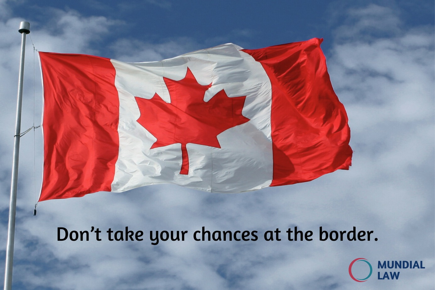 Canadian Flag in front of sky and clouds.